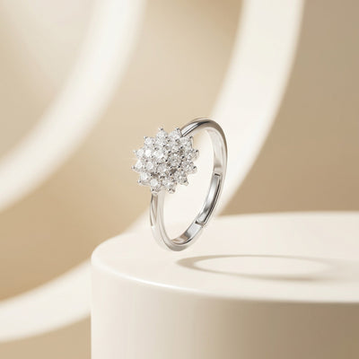 Silver ring with floral diamond design on a beige background