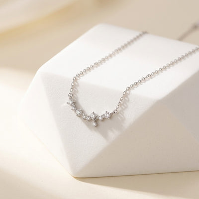 Silver necklace with small diamonds on a white cushion