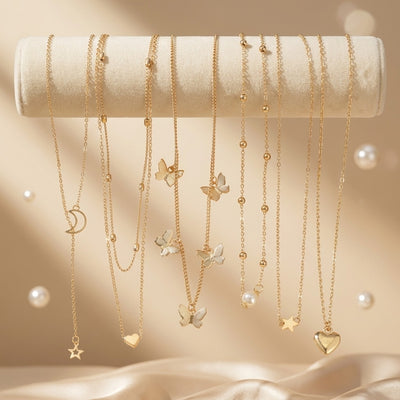 Gold necklaces with various pendants on a beige background